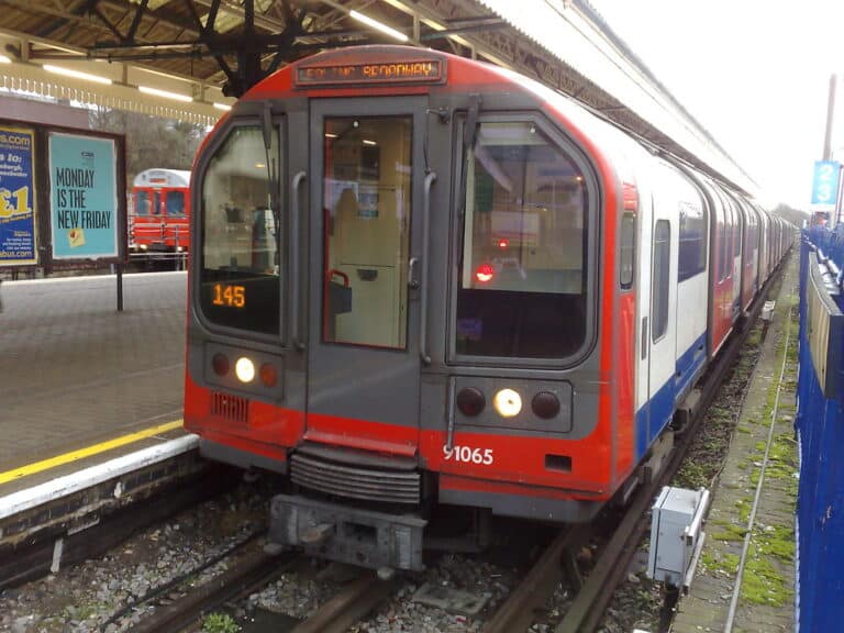 Central Line Underground train arriving at a London station platform