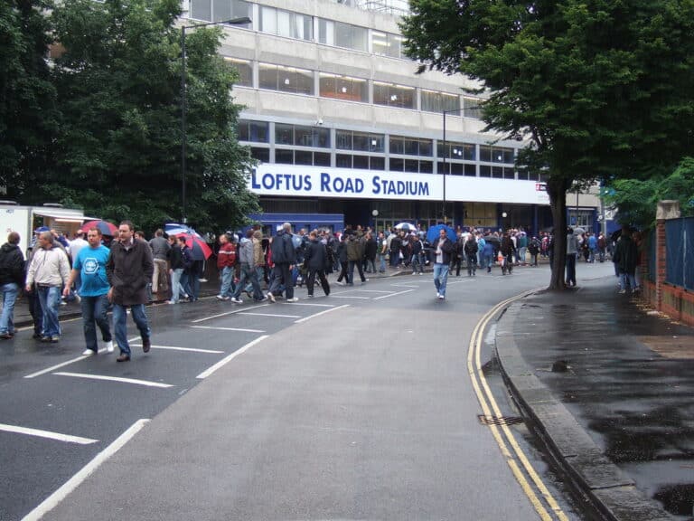 Fans walking toward Loftus Road football stadium in Shepherd's Bush