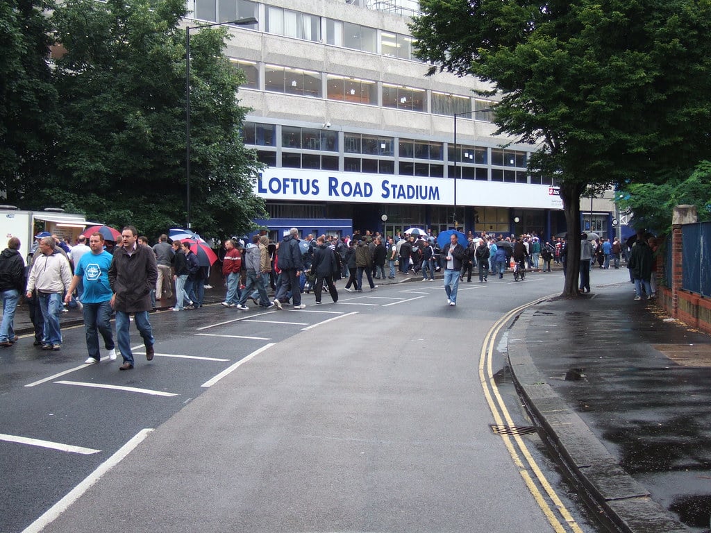 Fans walking toward Loftus Road football stadium in Shepherd's Bush
