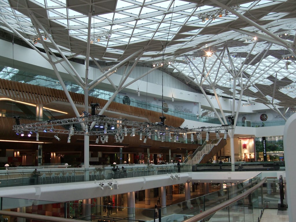Interior of Westfield London shopping centre with cinema signage